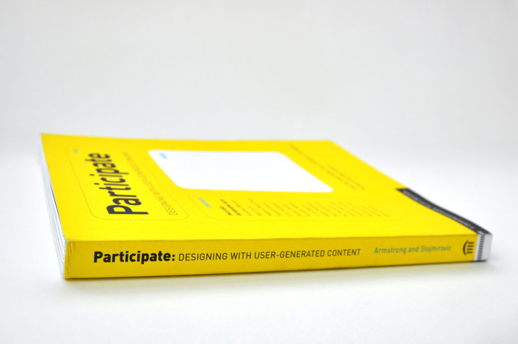 Yellow book. Spin reads: Participate: Designing with User Generated Content. Armstrong and Stojmirovic